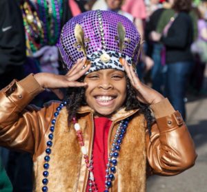 Child at Mardi Grad with Beeds. Photo by George Long