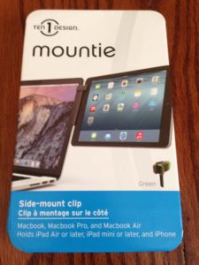 The Mountie is a side-mount clip that is black with green trim. It works with your Macbook laptops and other mobile Apple devices. And it will help streamline the way you work when traveling for business on the road. © Rob Hard 2015T