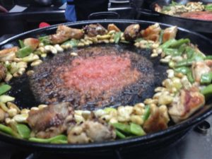 Cooking paella meat and vegetables
