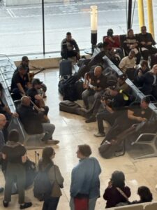 Random Musicians Perform at Madrid Barahas in Seats Near Gate