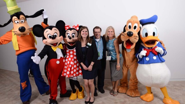 Hanging out at the GM Test Track corporate lounge with Disney's Fab 5. Left to right: Goofy, Mickey Mouse, Minnie Mouse, Kristen Rocco (AIBTM), Rob Hard (Business Travel Destinations), Mary Haban (Convention South), Pluto and Donald Duck. June 10, 2014. Image courtesy of Disney Meetings.